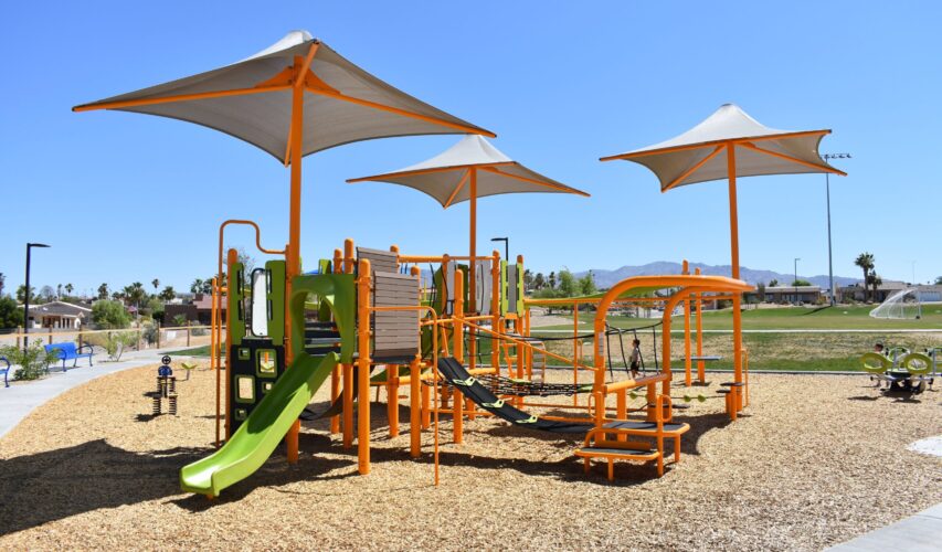 play structure beneath three sun shades