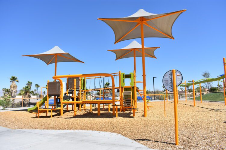 three sun shades near play structure