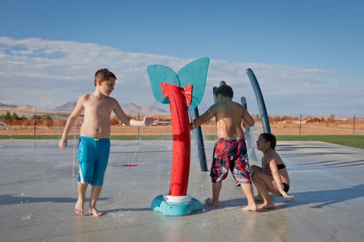 kids squirting water at each other