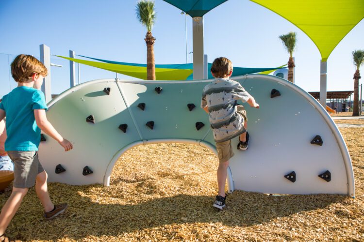 kids climbing a climbing wall