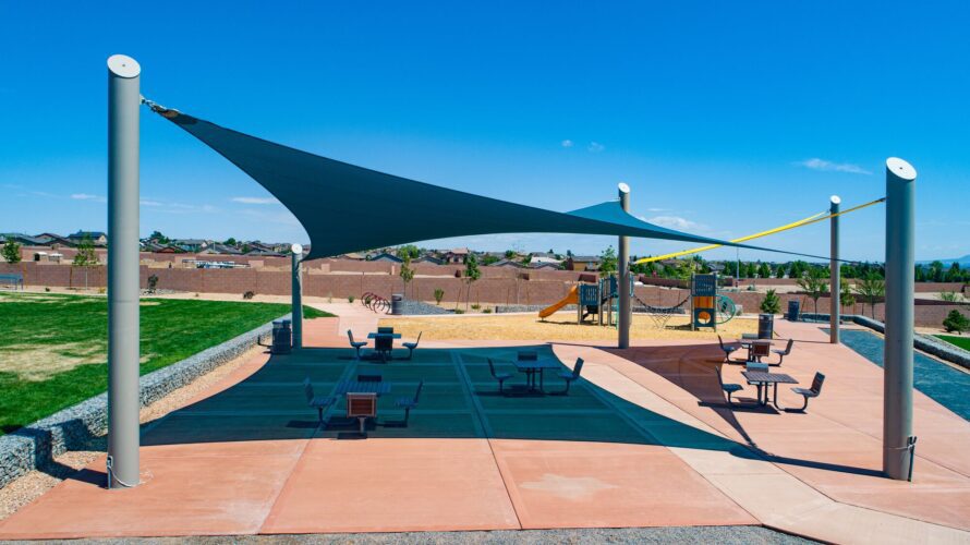 large sun shade over picnic tables