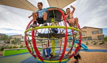 kids playing on a spinning wheel