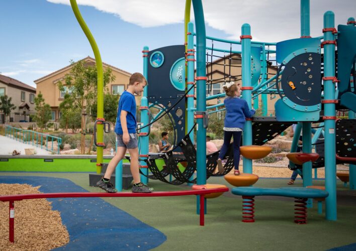 kid balancing across playground beam