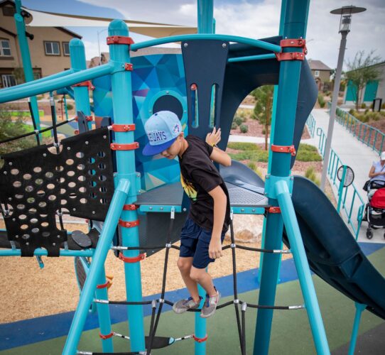 child walking across a net at the playground