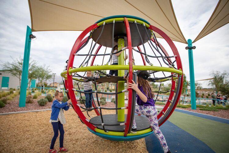 kids climbing inside playground wheel