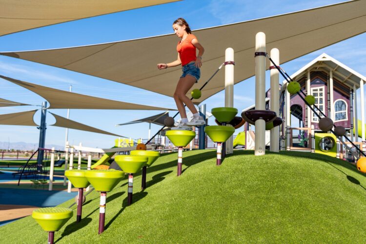 girl stepping down on the playground equipment