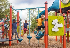 boys walking on color playground equipment