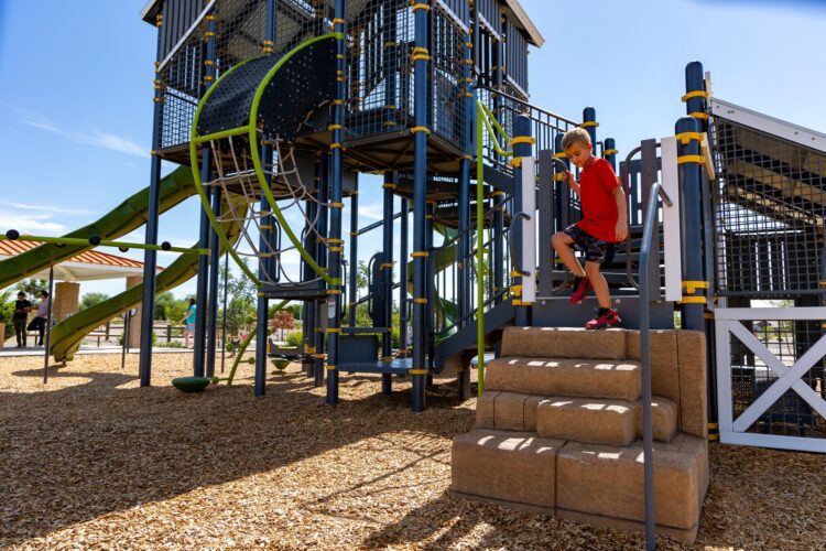 kid climbing down playground