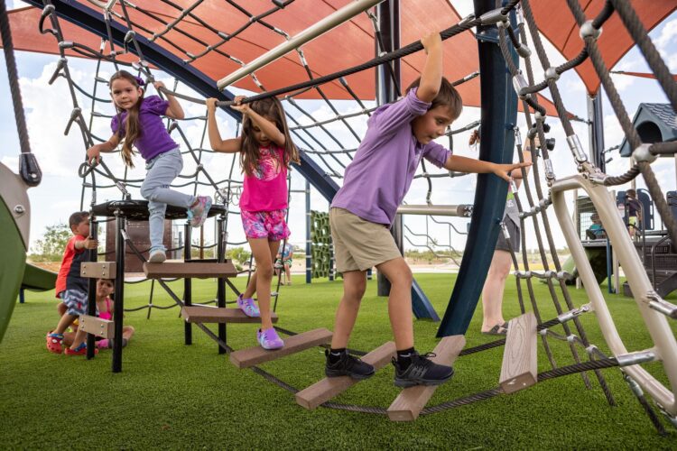 children climbing across swinging pathway