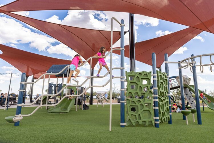 girls climbing up playground